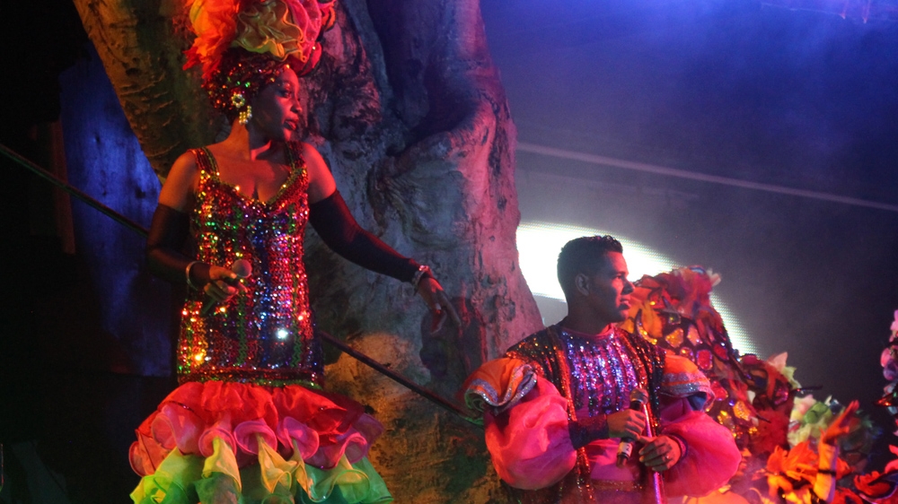 Tropicana performers dance on an outdoor stage [Stephanie Ott/Al Jazeera]