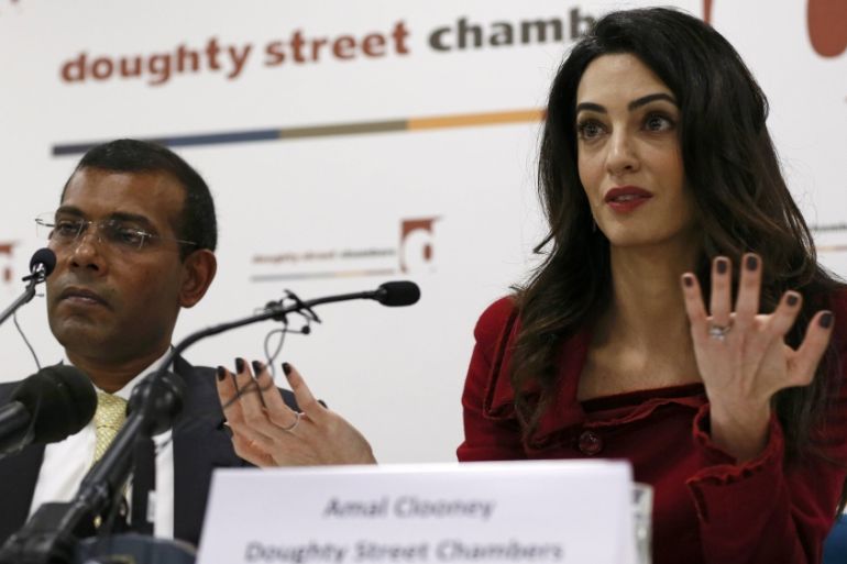 Lawyer Amal Clooney sits with Mohamed Nasheed during a news conference in central London