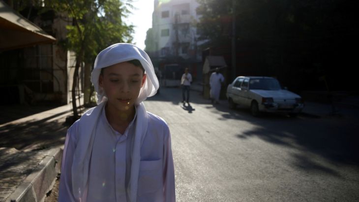 A boy walks on a street on the first day of Eid al-Adha celebrations