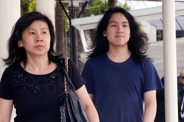 Teen blogger Amos Yee arrives with his mother at the State Courts in Singapore