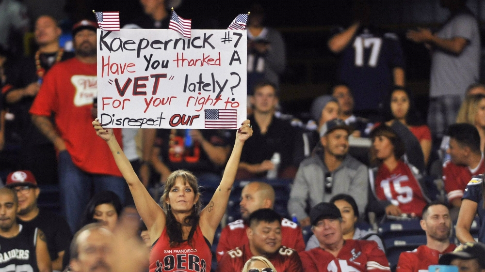 A San Francisco 49ers fan holds up a sign in referring to Kaepernick's protest during the second half of the game against the San Diego Chargers at Qualcomm Stadium [Reuters]