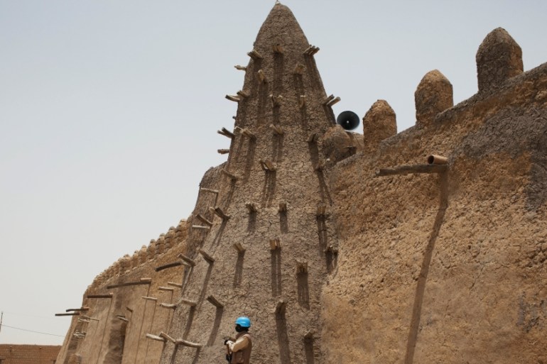 A UN peacekeeper stands guard at the Djinguereber mosque during a visit by a UN delegation on election day in Timbuktu