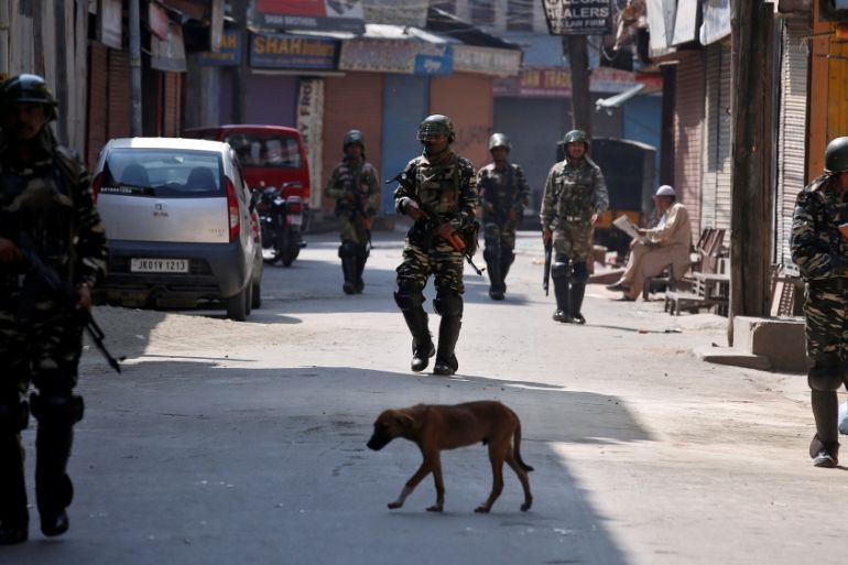 Indian policemen patrol a street during a strike called by Kashmiri separatists in Srinagar, against the recent killings in Kashmir region