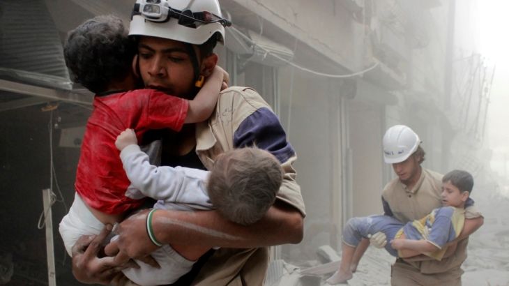 Members of the Civil Defence rescue children in Aleppo