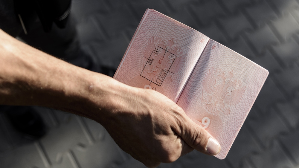 A Chechen shows his passport with a single stamp. Polish border guards stamp each page a maximum of three times. Chechens claim this is so the passport has to be replaced sooner [Ben Gerdziunas/Al Jazeera] 