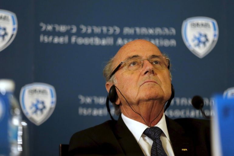 FIFA presidentSepp Blatter wears headphones during a news conference in Jerusalem