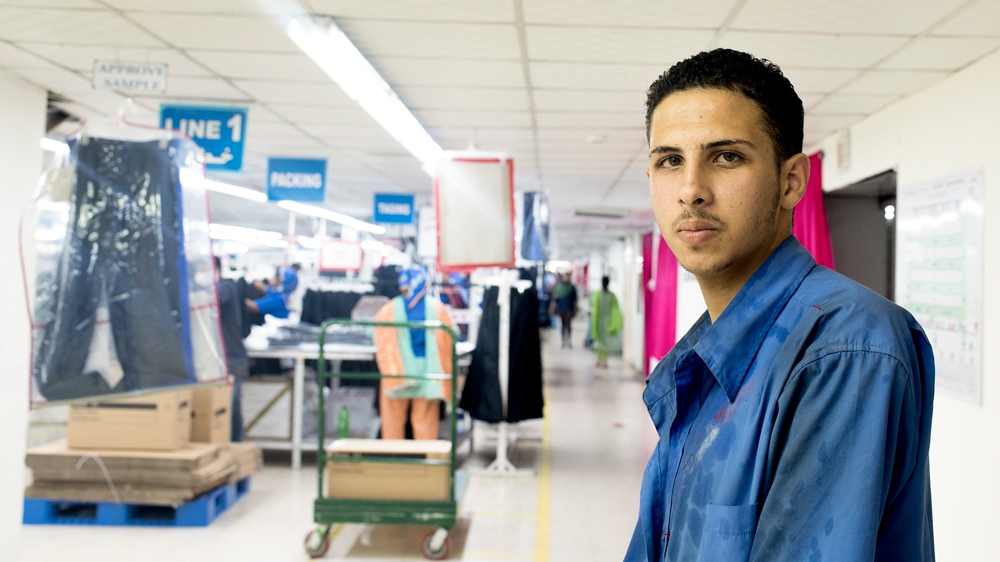 Ali Abdul Rahman, 20, is one of a handful of Syrians to have entered Jordan's textile industry since the sector opened to refugees earlier this year [Alisa Reznick/Al Jazeera]
