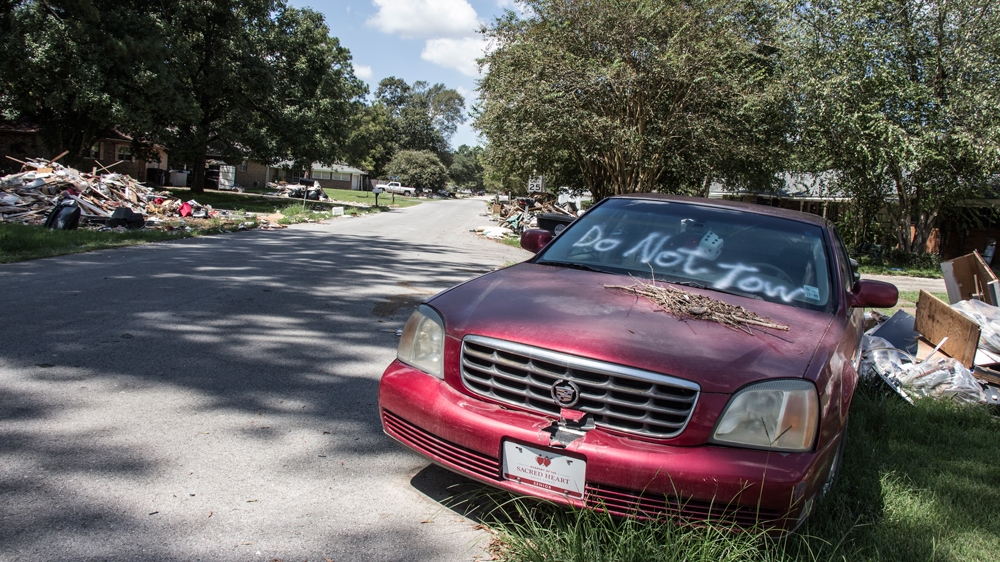 Immobile cars are parked in yards and on sidewalks throughout Baton Rouge neighbourhoods [Shaghayegh Tajvidi/Al Jazeera]