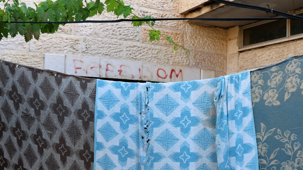The blankets were hung in order to block out Israeli settlers who would stand naked at the window and make obscene gestures, the Kurd family says [Jaclynn Ashly/Al Jazeera]