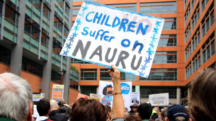 File picture of activists holding placards and chanting slogans as they protest outside the offices of the Australian Immigration Department in Sydney, Australia