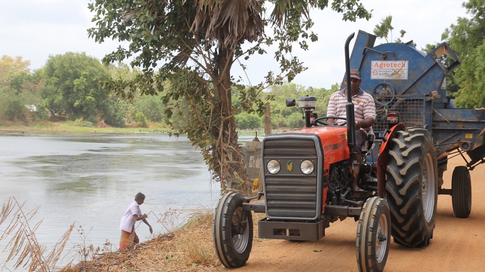The restored bund is so broad it is now a main point of access for this Galgamuwa village. It is used to transport crops and bring materials to the fields. [Tharuka Dissanaike/ UNDP/ Al Jazeera] 