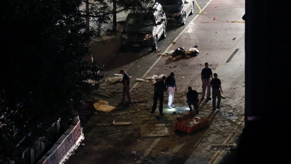 
Police combing the area around the scene of an explosion found a pressure cooker nearby connected to a cell phone [EPA]
