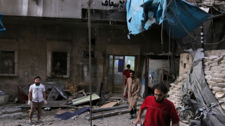 Medics inspect the damage outside a field hospital after an airstrike in the rebel-held al-Maadi neighbourhood of Aleppo