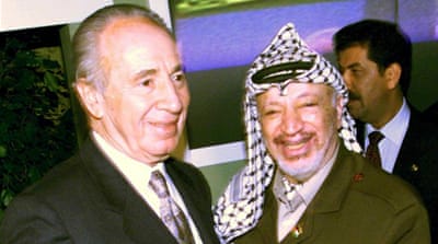 Yasser Arafat and Shimon Peres share a laugh during a meeting in September 1999 [EPA]