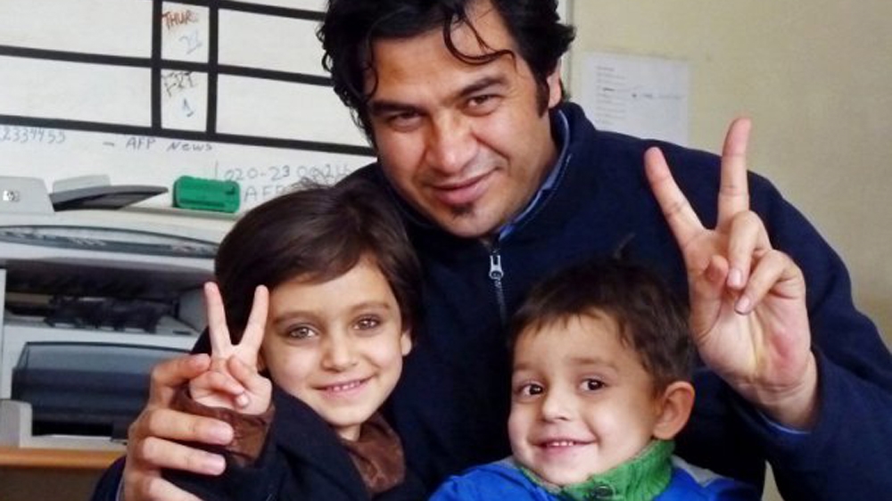 Afghan journalist Sardar Ahmad and his children [Al Jazeera]