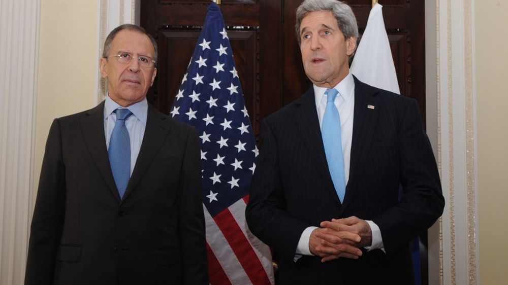 Kerry, right, addressing reporters as Lavrov looks on at Winfield House, the US ambassador's residence in London, March 2014 [EPA]