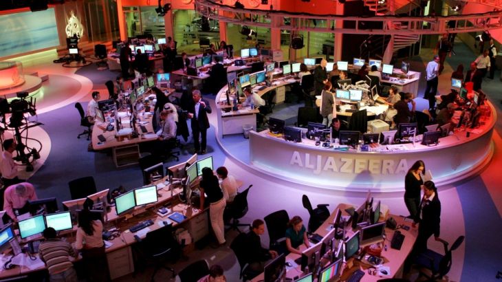 File photo of staff working at the English-language newsroom at the headquarters of the Qatar-based Al Jazeera satellite channel in Doha