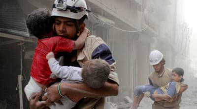 Members of the Civil Defence rescue children after what activists said was an air strike by forces loyal to Assad in al-Shaar neighbourhood of Aleppo, Syria [Reuters]