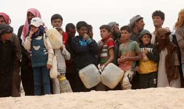 Syrian refugees arrive at the Jordanian military crossing point of Hadalat