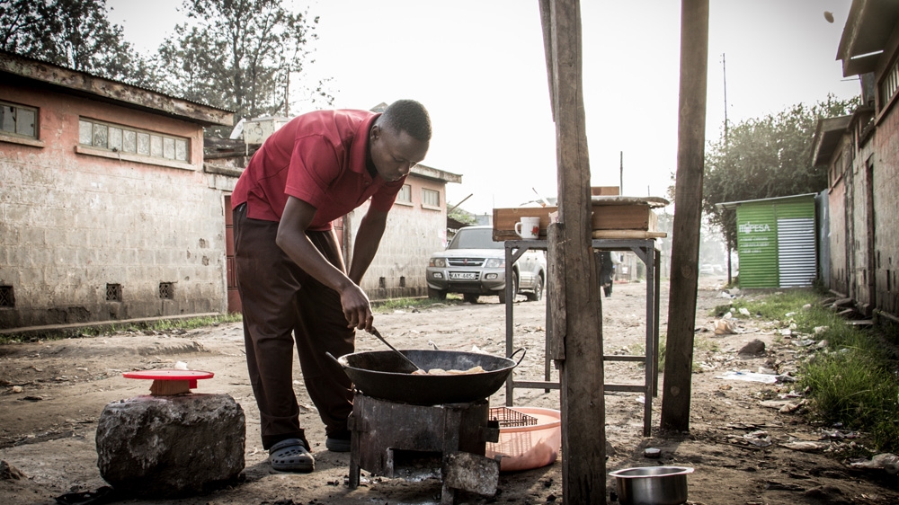 Nicky Ombati makes local Kenyan doughnuts called 'mandazi'. Finding formal work in Kenya is a struggle for many of the country's youth [Humphrey Odero/Al Jazeera] 