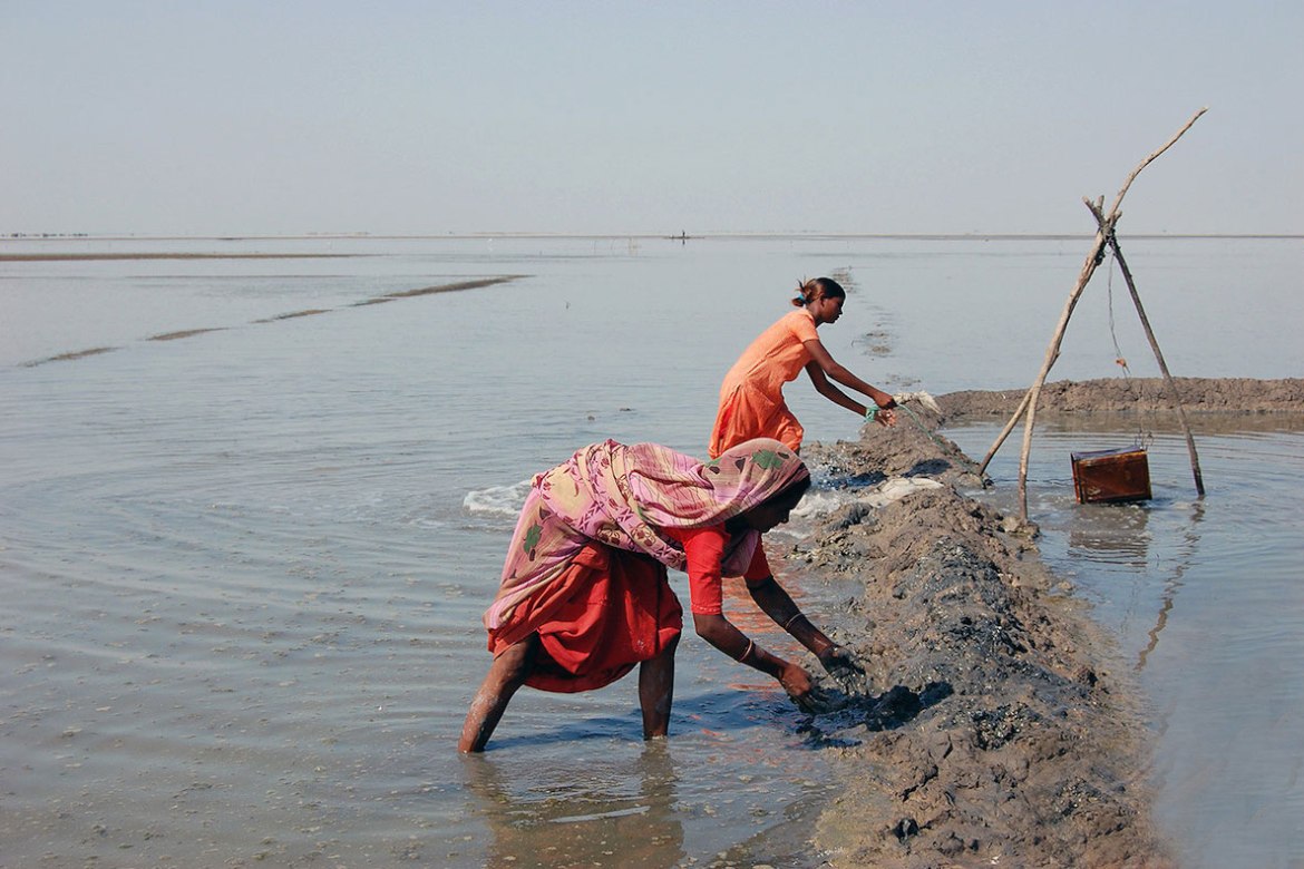 Work in the fields start in early October, when salt farmers begin the embankment process in the salt flats, still submerged with monsoon water. [Ajay Dhamecha/Al Jazeera]