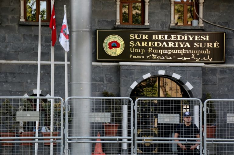 A riot police officer stands guard in front of Sur municipality office, following the removal of the local mayor from office after he was deemed to support Kurdish militants, in Diyarbakir