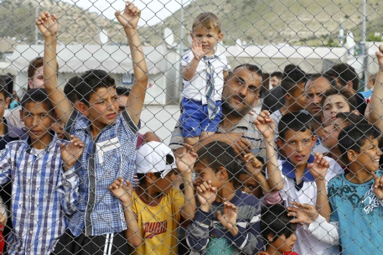 Refugees and their children wait for the arrival of officals at Nizip refugee camp near Gaziantep