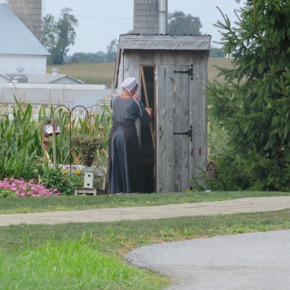 An Amish woman in traditional attire works in her garden. 'The Amish live a patriarchal society, and usually adhere to traditional gender roles,' Kopko told Al Jazeera [Jessica Sarhan/Al Jazeera]