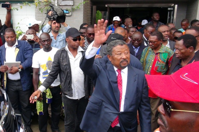 Gabonese opposition candidate Jean Ping greets supporters outside his campaign headquarters after proclaiming that he won the presidential election in Libreville