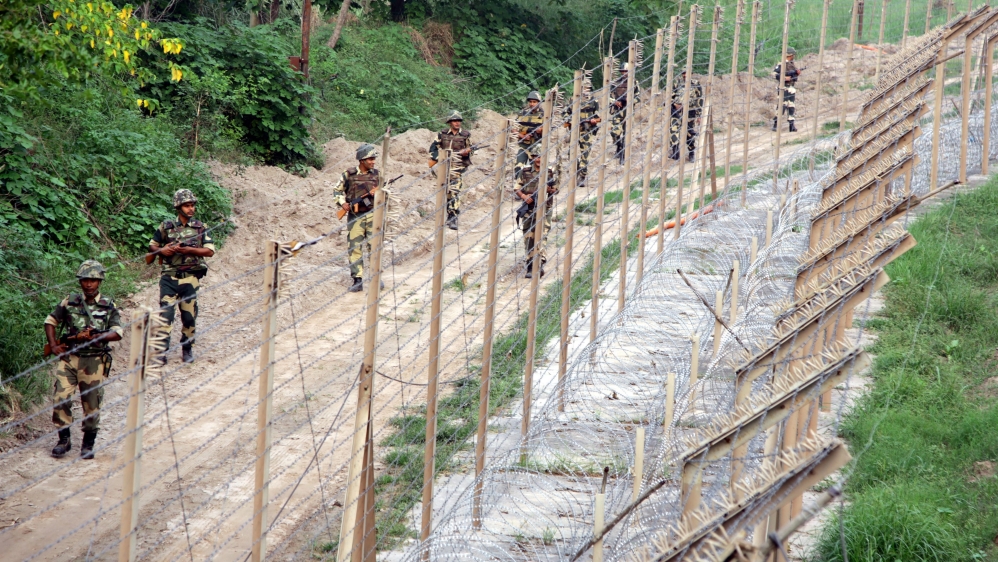 Indian Border Security Force soldiers patrol near the fence at the India-Pakistan border in Akhnoor sector [File: EPA]