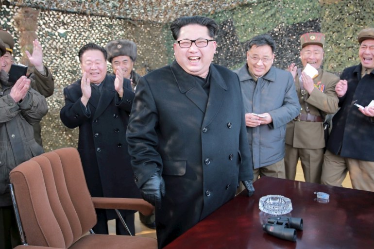 North Korean leader Kim smiles as he guides a test fire of a new multiple launch rocket system in this undated photo released by North Korea''s KCNA in Pyongyang