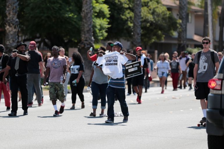 Protesters march at Mollison in El Cajon to protest the fatal shooting of an unarmed black man Tuesday by police in El Cajon