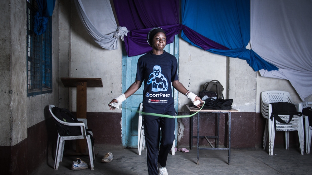 Veronica Mbithe, 20, warming up inside the Muthurwa gym that houses the Dallas Boys club [Humphrey Odero/Al Jazeera]   