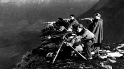Republican Loyalists manning rifles and machineguns on mountain top position against Nationalist rebels during fighting in the Spanish civil war [Getty]