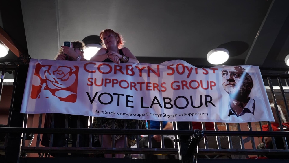 Corbyn supporters celebrate the announcement [Shafik Mandhai/Al Jazeera]