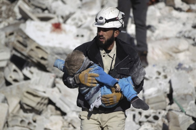 Syria Civil Defence caries child after air strike in Idlib