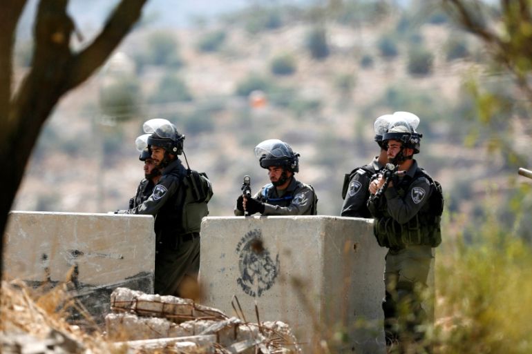 Israeli border policemen stand guard at the scene where a Palestinian was shot and killed by Israeli forces in the West Bank village of Silwad