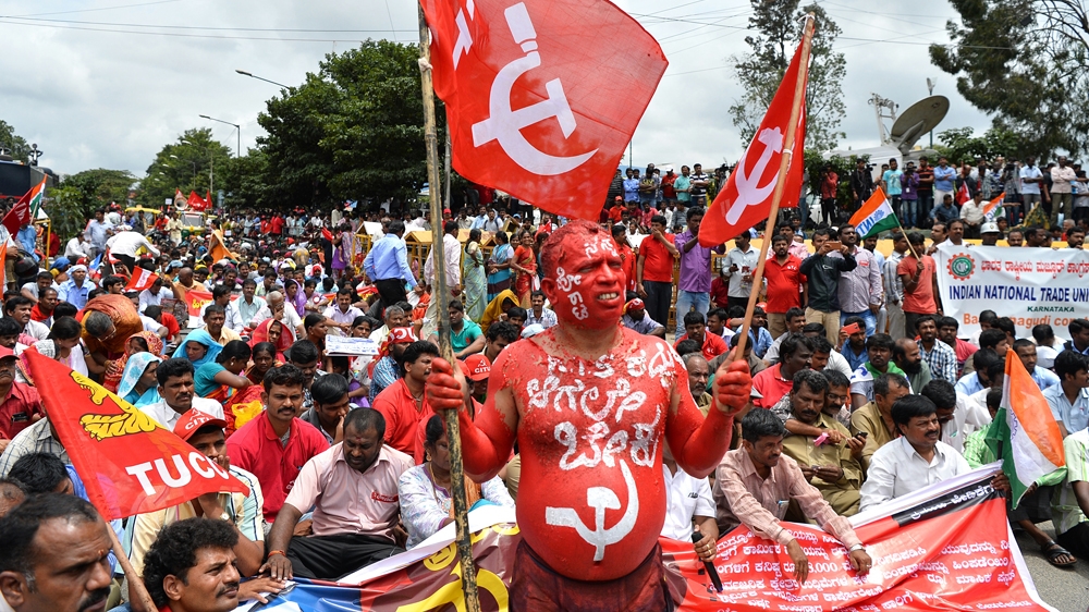 Workers are demanding that the government dump plans to close unproductive factories [Manjunath Kiran/AFP]