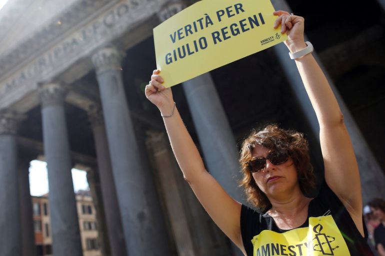 An Amnesty International activist holds a placard reading "truth for Giulio Regeni" as she takes part in a performance to protest against enforced disappearance in Rome