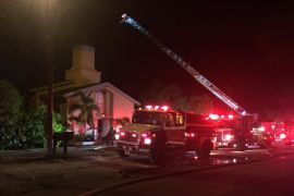 Emergency personnel are seen at the Islamic Center of Fort Pierce which was set on fire, in Fort Pierce