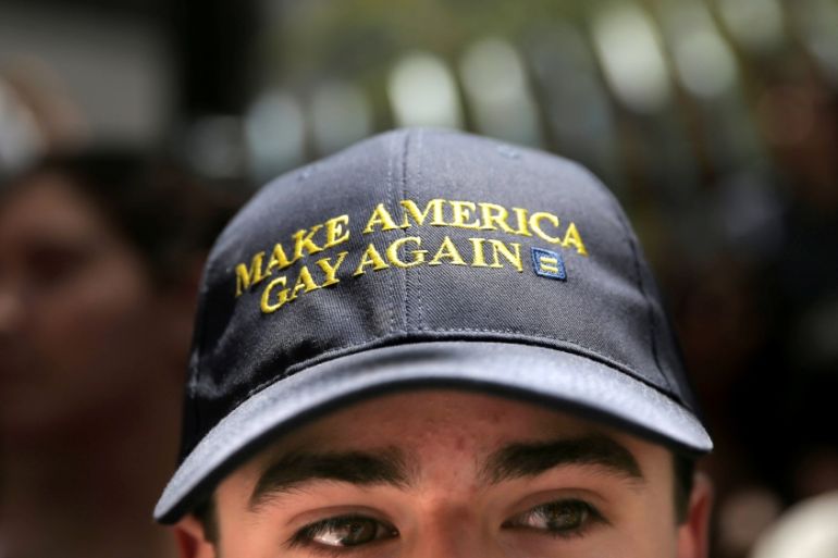 A man wears a hat that says "Make America Gay Again," at San Francisco LGBT Pride Parade in San Francisco, California