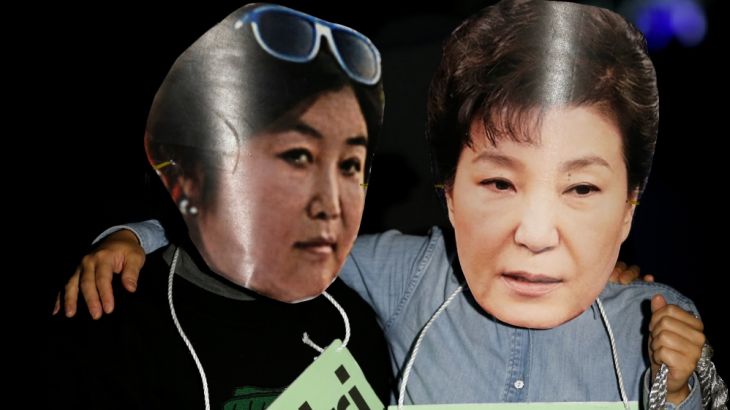 Protesters wearing cut-out of South Korean President Park Geun-hye