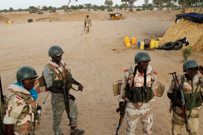 Niger soldiers gather as the prepare to guard towards the border with neighbouring Nigeria, near the town of Diffa