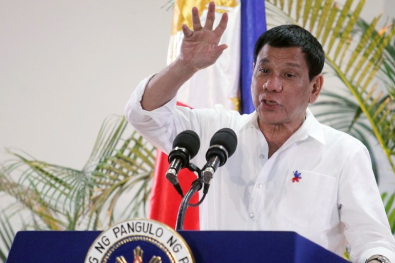 Philippine President Rodrigo Duterte gestures while answering questions during a news conference in Davao city