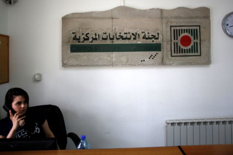 Palestinian employee speaks on the phone in the office of the Central Elections Commission in the West Bank town of El Bireh