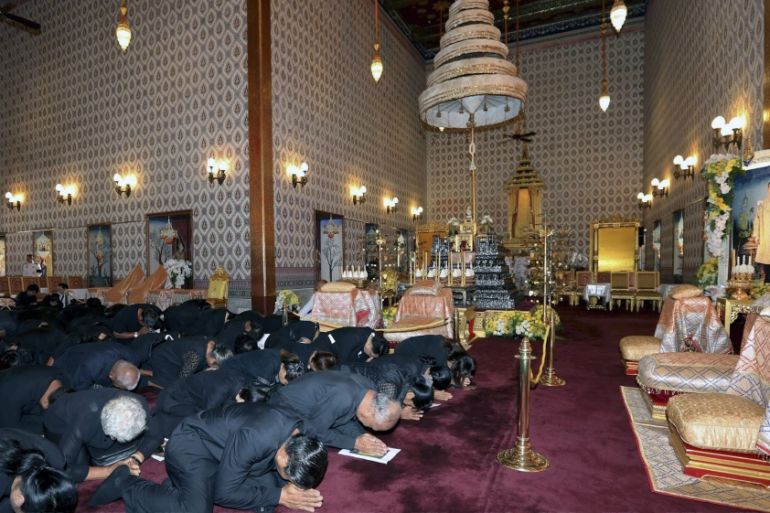 Thai mourners pay their respects in front of a royal urn of the late King Bhumibol Adulyadej