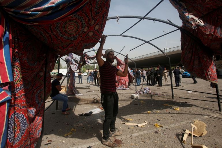 A man reacts at the site of a suicide bomb attack in Baghdad