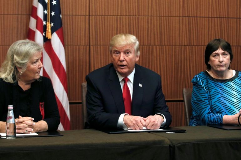 Republican presidential nominee Donald Trump sits with Kathy Shelton and Juanita Broaddrick in a hotel conference room in St. Louis, Missouri