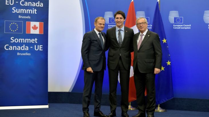 Canada''s PM Trudeau poses with EU Council President Tusk and EC President Juncker before signing the CETA at the European Council in Brussels