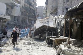 A civil defence member runs at a market hit by air strikes in Aleppo''s rebel-held al-Fardous district, Syria [REUTERS]